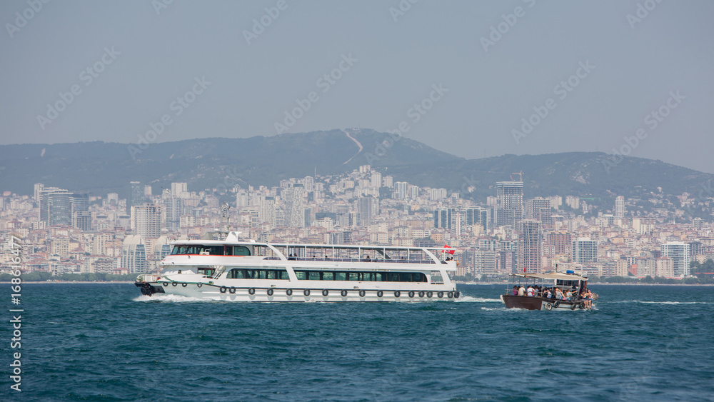 Passenger ferryboat in the middle of Bosphorus Strait Turkey. Against the background of the city of Istanbul.