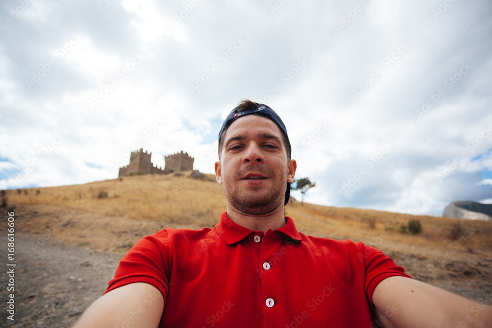 Handsome guy making selfie Sudak in the mountains, Russia