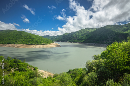 Scenic view on lake in Georgia mountains. Clouds reflect in water