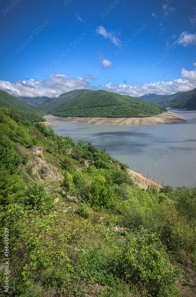 Scenic view on lake in Georgia mountains. Clouds reflect in water