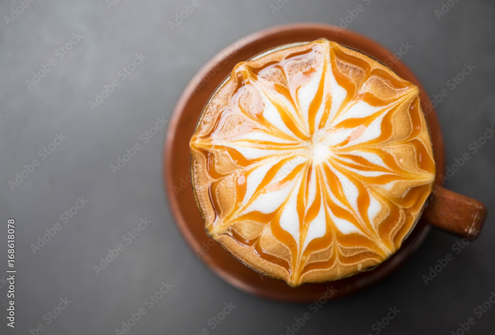 Cup of coffee with caramel on top with gray background Cup of coffee with caramel on top with gray background
