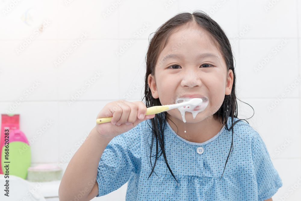 happy asian cute girl brushing teeth in bathroon happy asian cute girl brushing teeth in bathroon