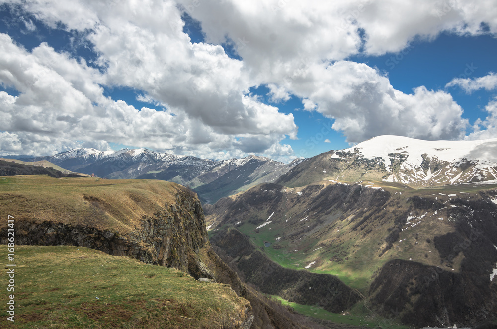 Fototapeta premium Scenic view on Caucasus mountains in Georgia. A small river flows down the gorge