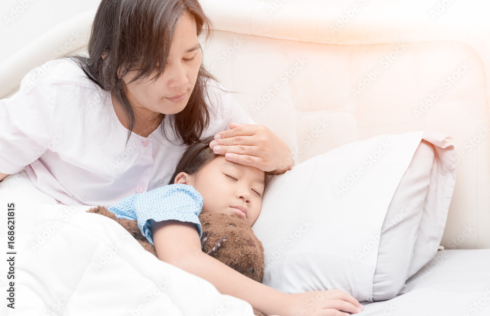 Sick girl laying in bed and mother hand taking temperature. Sick girl laying in bed and mother hand taking temperature.