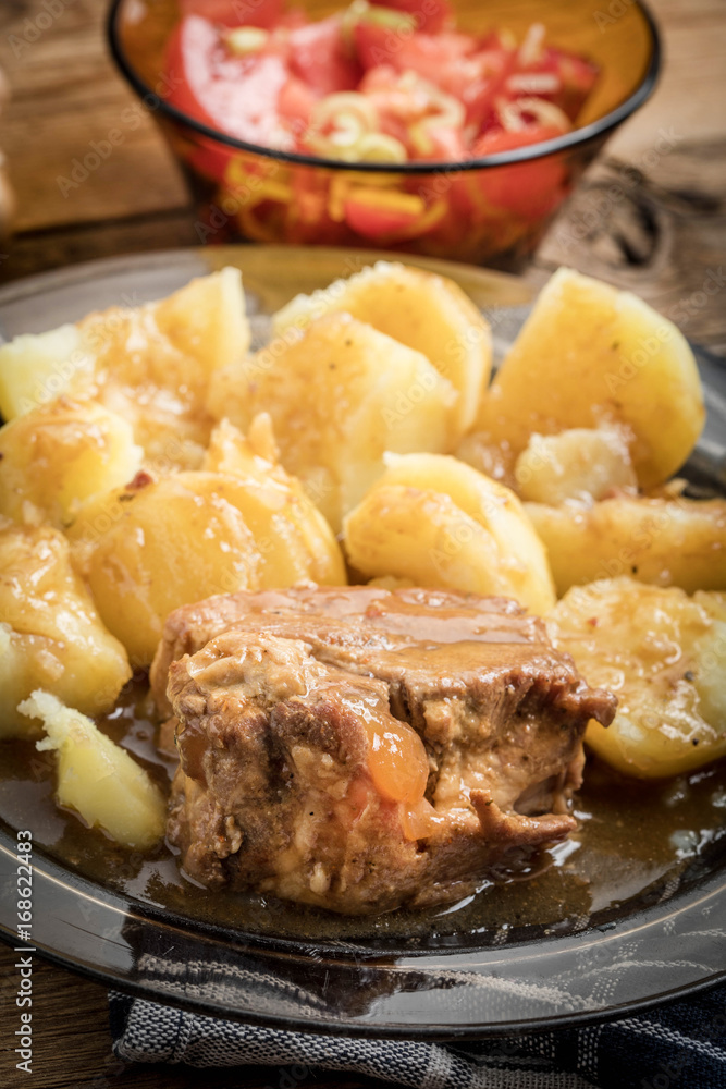 Stewed pork meat served with potatoes Stewed pork meat served with potatoes
