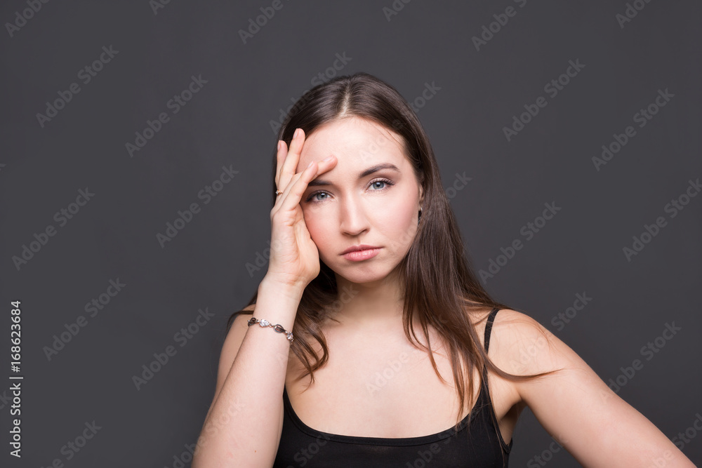 Emotional stressed woman portrait on dark background Emotional stressed woman portrait on dark background
