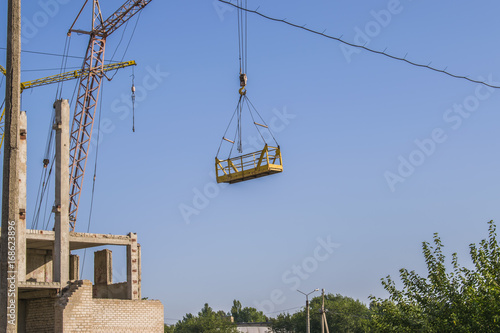 Construction site. Contemporary urban landscape. Nice photo of unfinished building with blue sky in the background in a sunny day. Developing of modern civil engineering. photo