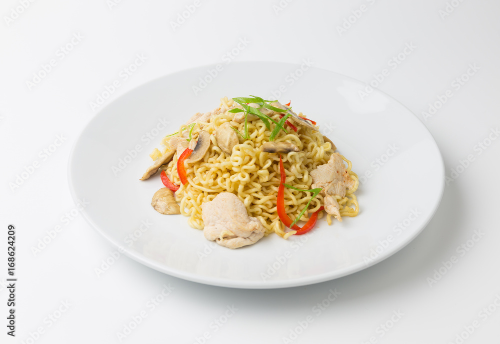 Stir-fry noodles with chicken meat, mushroom and red capsicum in a plate on white background copy space
