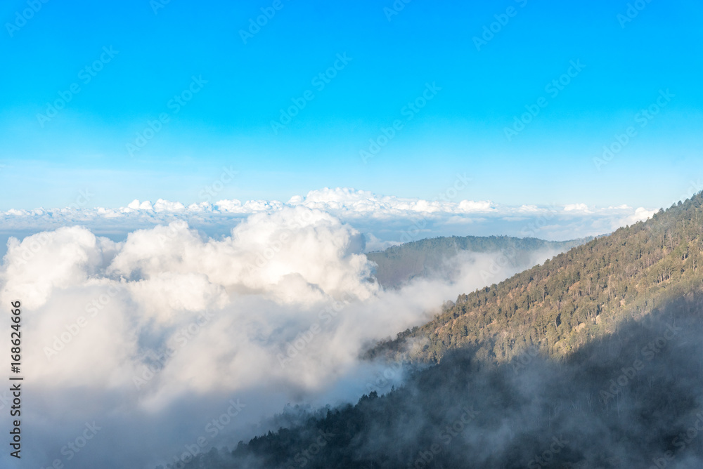 Fototapeta premium Mountain view above the cloud and blue sky. Rinjani mountain, Lombok island, Indonesia.