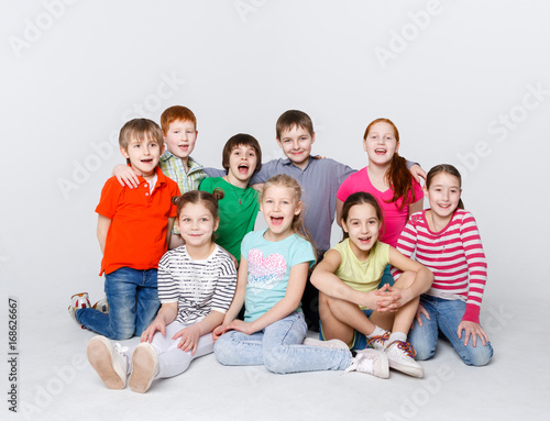 Happy kids sitting on floor at studio, copy space