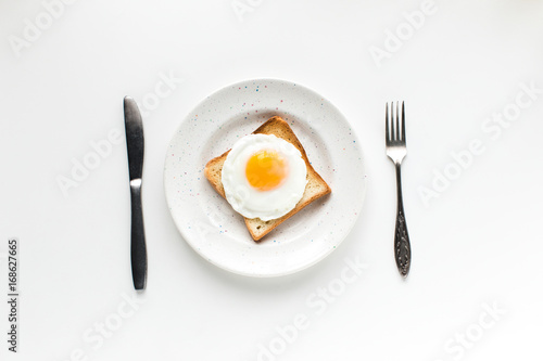 top view of breakfast with fried egg on toast, isolated on white