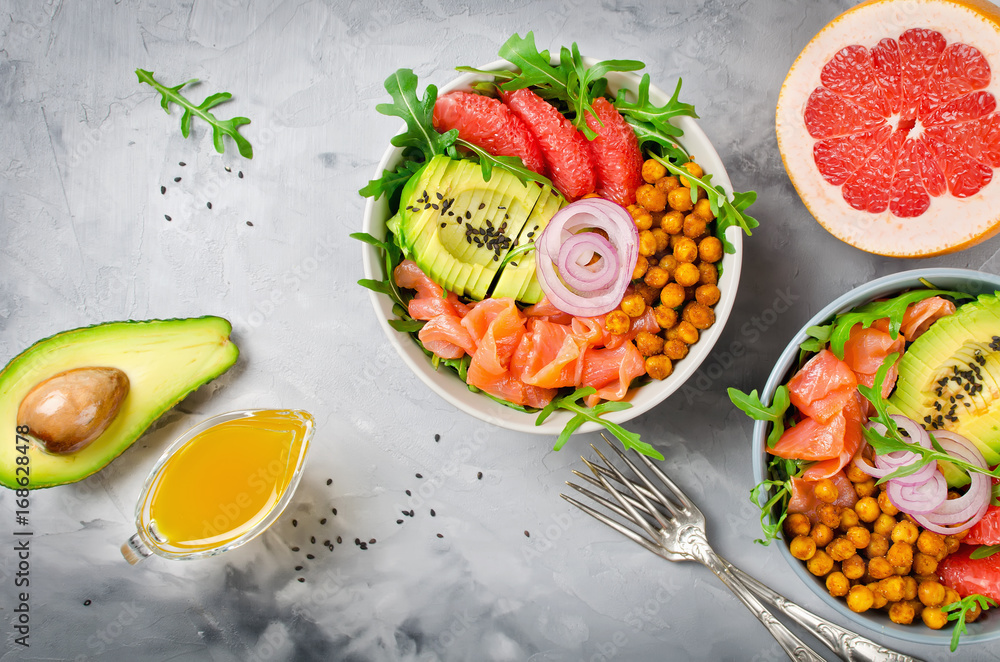 Healthy salad bowl with salmon, grapefruit, spicy chickpeas, avocado, red onion and arugula Healthy salad bowl with salmon, grapefruit, spicy chickpeas, avocado, red onion and arugula