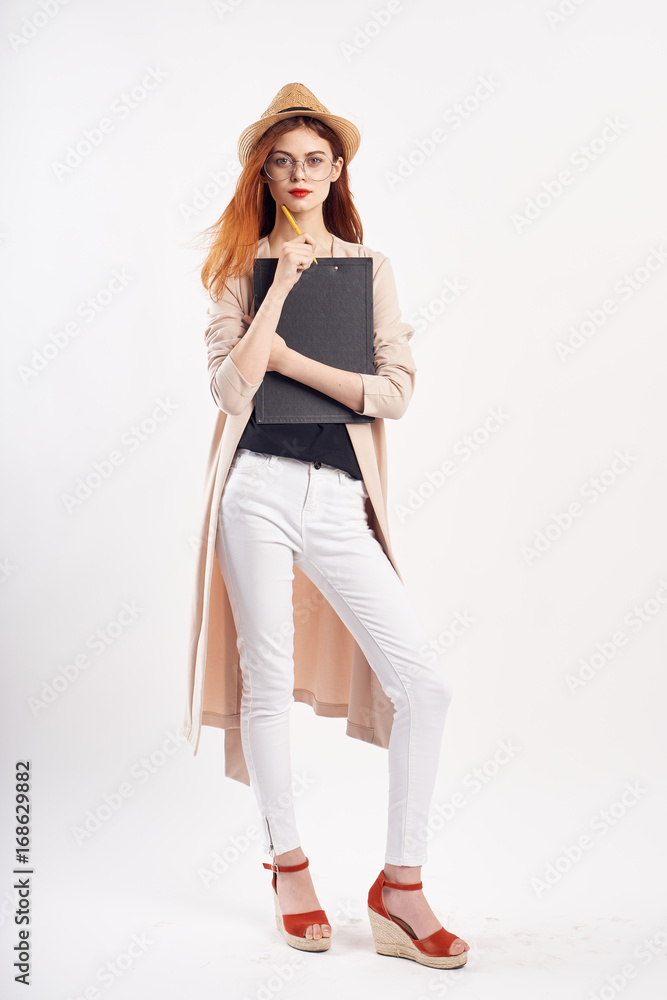 Beautiful young woman on a light background in a white hat and wearing full-length glasses, fashion, style, beauty Beautiful young woman on a light background in a white hat and wearing full-length glasses, fashion, style, beauty