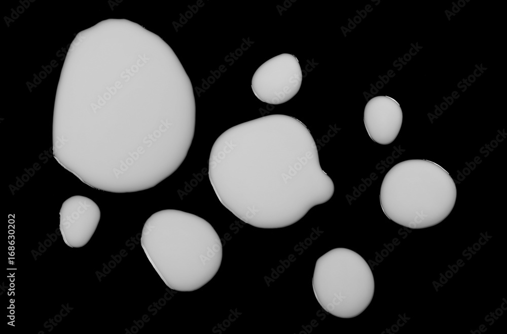 Milk splashes isolated on black background, top view, clipping path Milk splashes isolated on black background, top view, clipping path