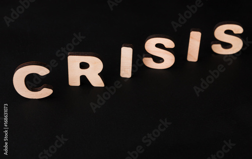 Word Crisis on black background photo