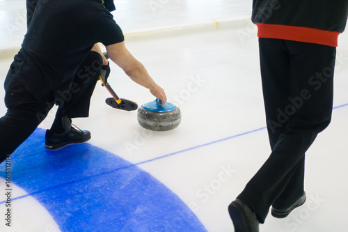 Team members play in curling at championship