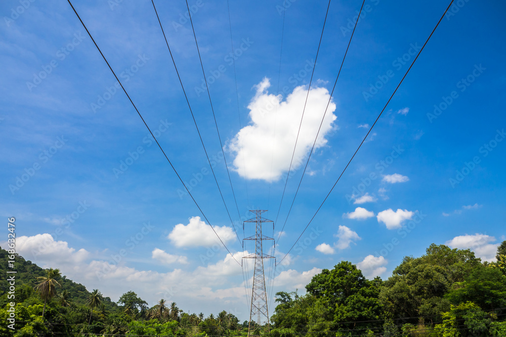 High voltage electric tower on the mountain and blue sky background.