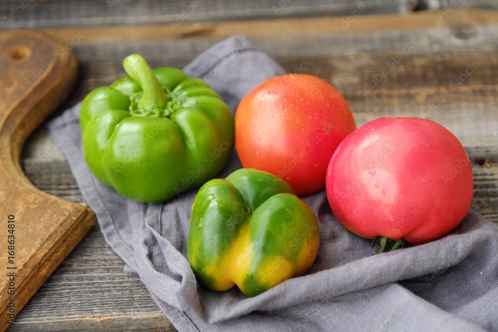 Fresh tasty vegetables on wooden background view 