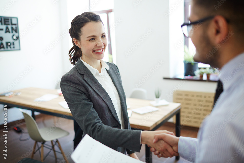 Successful man and woman greeting one another after making deal Successful man and woman greeting one another after making deal