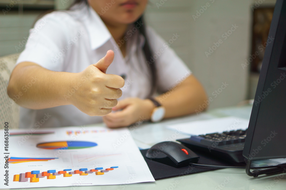 close up young businesswomen  thumb up for her successful in her business agreement or career or young universities student thumb up for her successful education.  study or business success concept