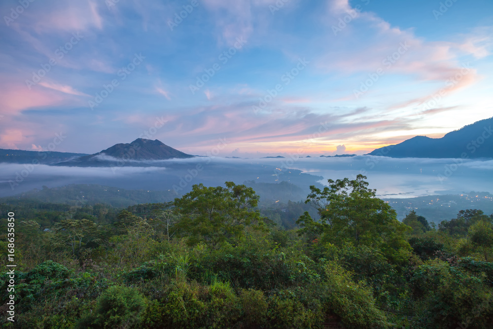 Fototapeta premium Kintamani volcano and Lake Batur in the morning, viewed from Penelokan are a popular sightseeing destination in Bali's central highlands, Indonesia.