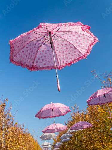 Pink umbrellas in the sky