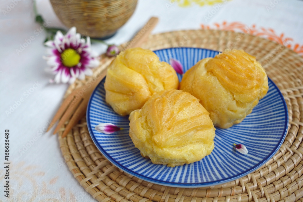 Homemade eclair on a plate served with tea or coffee Homemade eclair on a plate served with tea or coffee