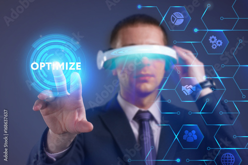 Business, Technology, Internet and network concept. Young businessman working on a virtual screen of the future and sees the inscription: Optimize