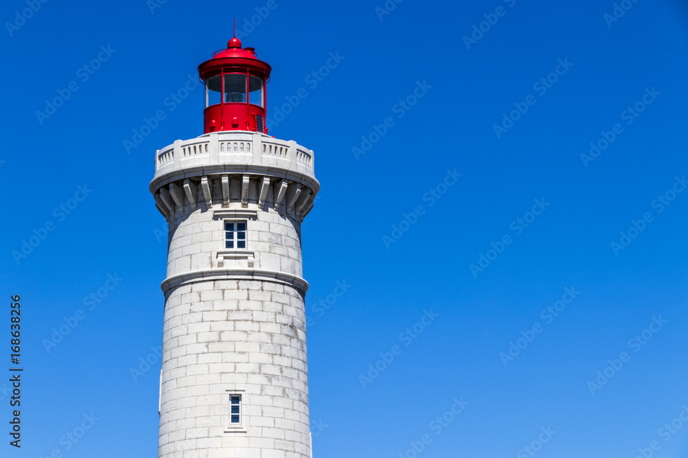 Close-up view of the Phare du Mole Saint-Louis, a white and red lighthouse in Sete, Southern France