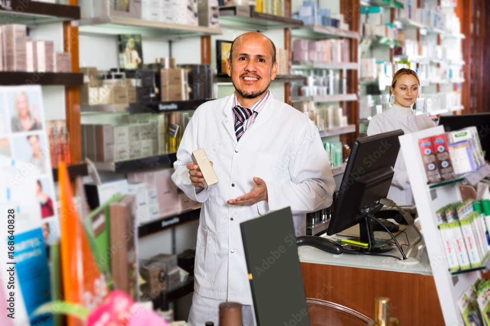 ﻿pharmacists standing with a cash desk