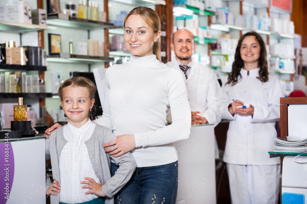 Mother with a girl in the pharmaceutical store