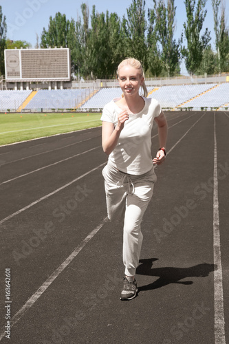 Young beautiful woman runni...