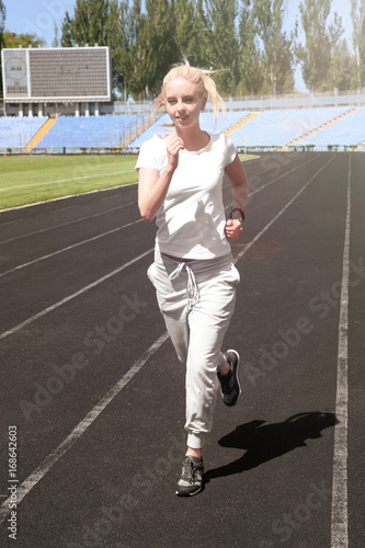Young beautiful woman runni...