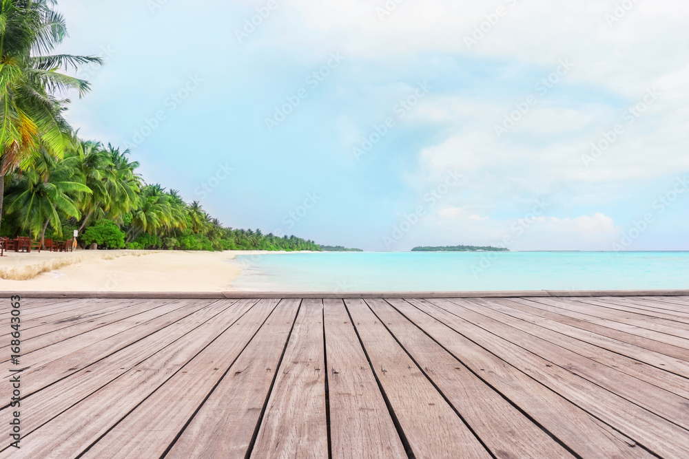 View of tropical beach from wooden pontoon on summer day View of tropical beach from wooden pontoon on summer day