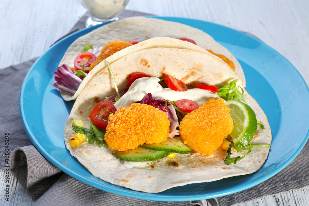 Plate with delicious fish tacos on white wooden background Plate with delicious fish tacos on white wooden background
