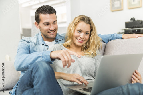 Young couple making the most of new technologies in their house