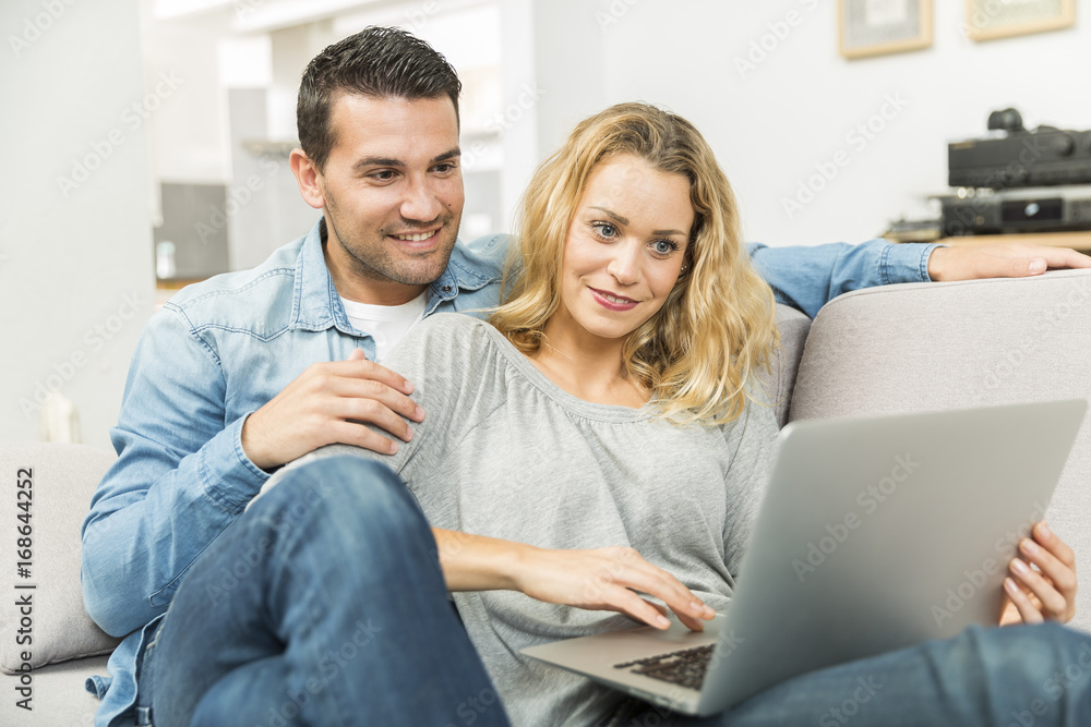 Young couple making the most of new technologies in their house Young couple making the most of new technologies in their house