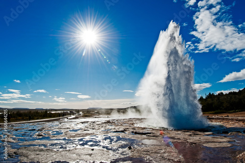 Back lit of Stokkur geyser with sunburst. Strokkur is a fountain geyser located in a geothermal area beside the Hvita River in Iceland in the southwest part of the country, east of Reykjavík.