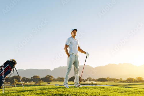 Caucasian male golfer standing on golf course