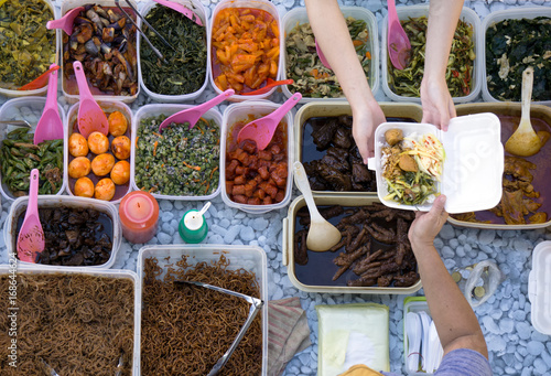 Photography Top view of unidentified vendor and customer at the food stall in Kota Kinabalu city food market
