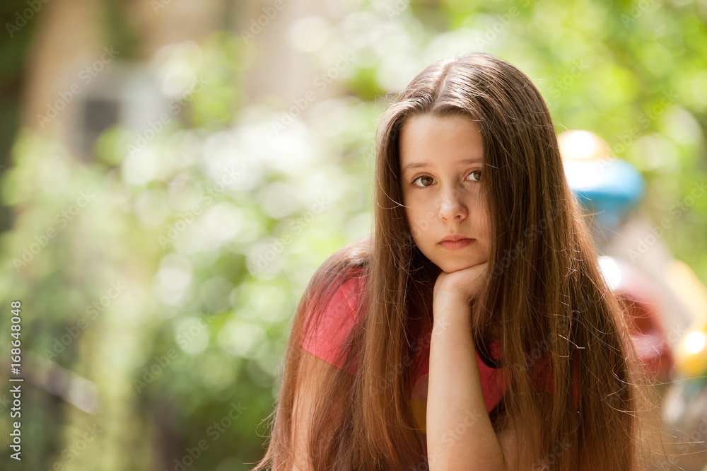 Beautiful teenage girl with a pensive and sad face expression Beautiful teenage girl with a pensive and sad face expression