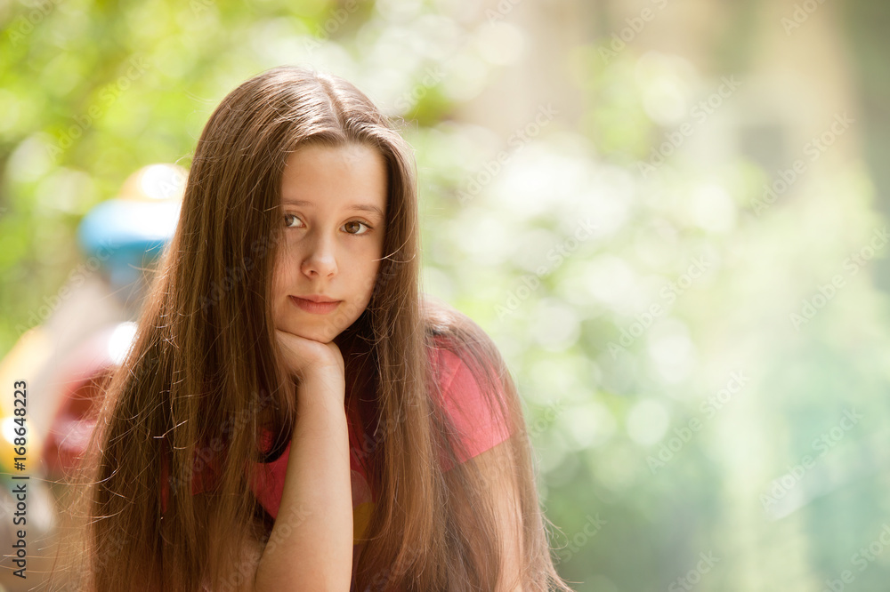 Obraz premium Beautiful teenage girl with a smiling and calm face expression