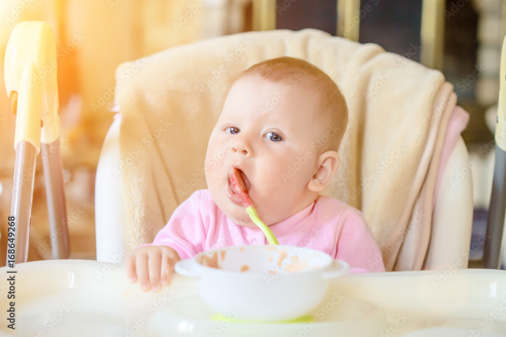 A cheerful happy child eats porridge. A cheerful happy child eats porridge.