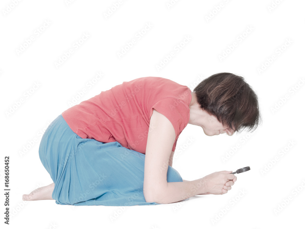 woman studying something under the magnifying glass. Crouched. White background. woman studying something under the magnifying glass. Crouched. White background.