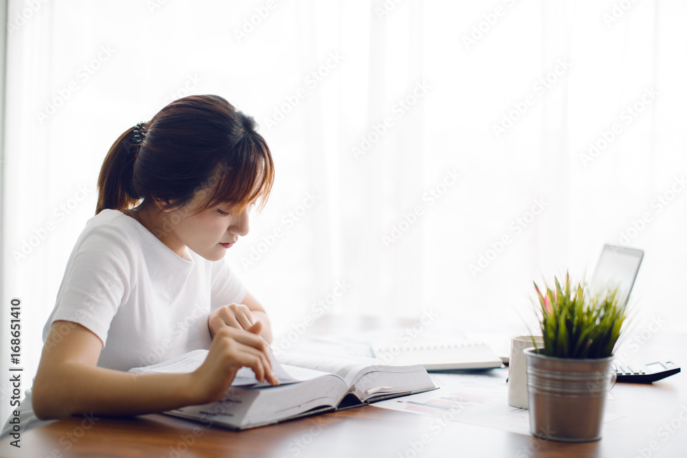 Young Asia woman reading a book in the office Young Asia woman reading a book in the office