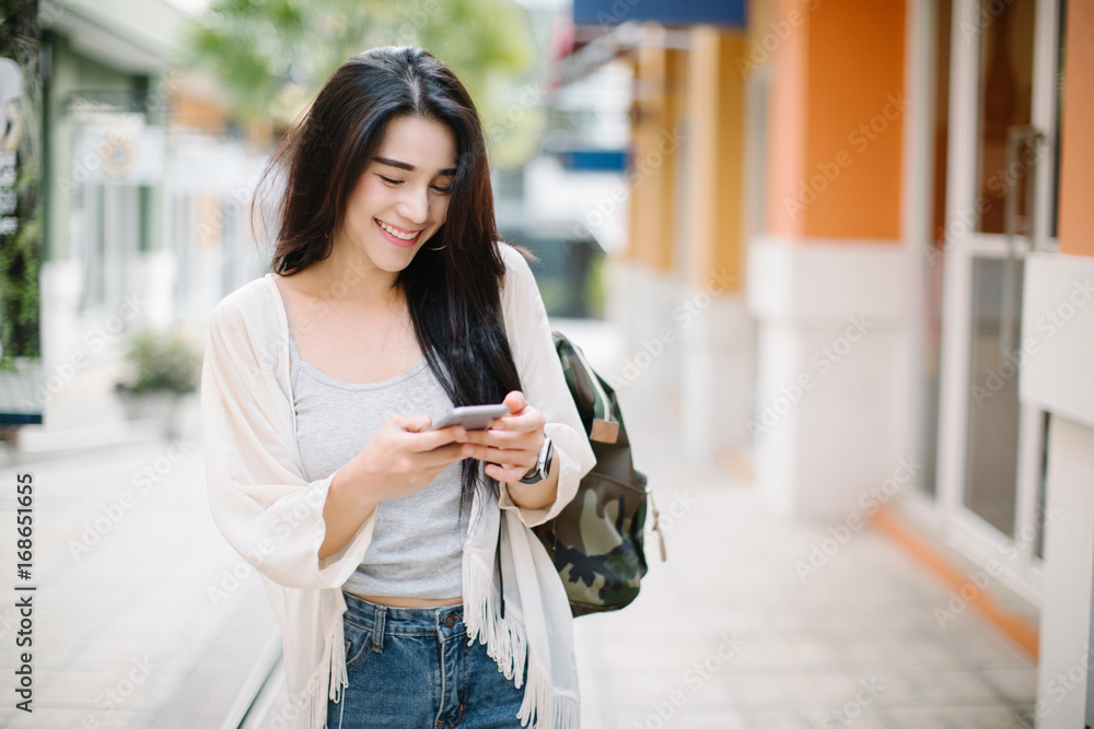 Fototapeta premium Asia woman using phone on the street
