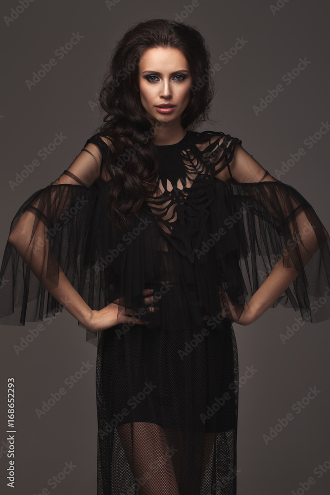 Young slim girl in black sexy fashionable dress. Young slim girl in black sexy fashionable dress.