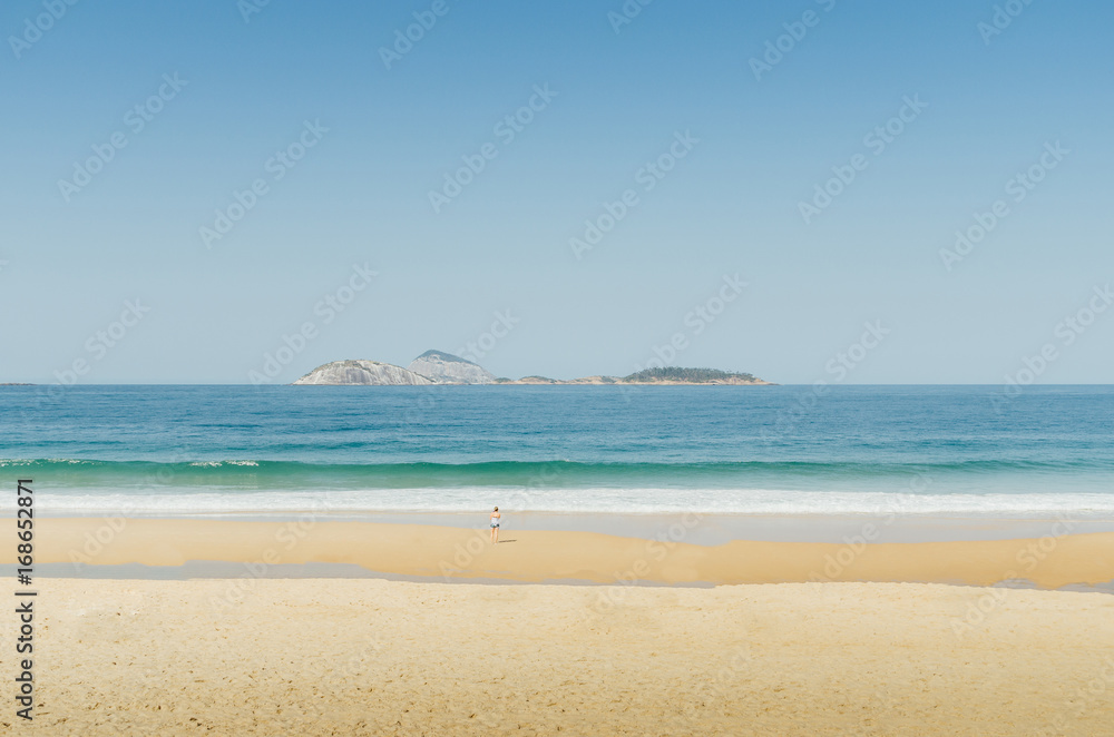 One woman in a deserted tropical beach with copy space - sense of scale