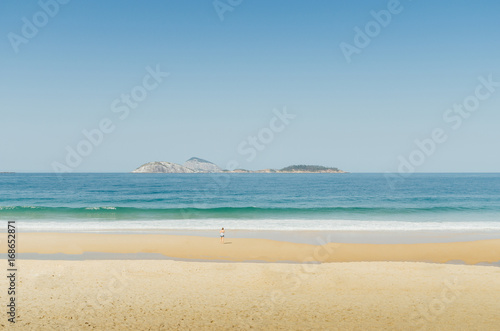 One woman in a deserted tropical beach with copy space - sense of scale