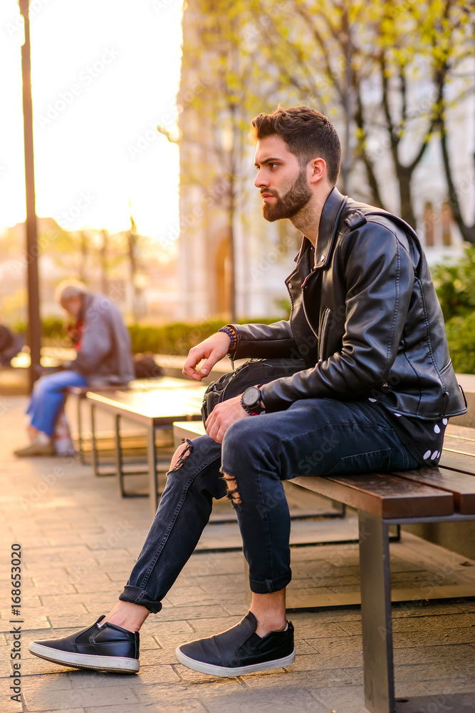 Young man sitting on a bench Young man sitting on a bench